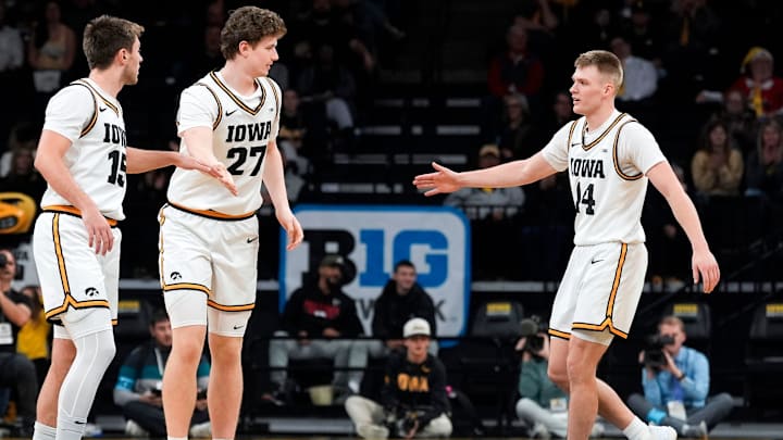 Iowa guard Bennett Stirtz (14) and Iowa guard Brendan Hausen (15) high-five Iowa center Trevin Jirak (27) during a game against the Western Michigan Broncos Dec. 14, 2025 at Carver-Hawkeye Arena in Iowa City, Iowa.
