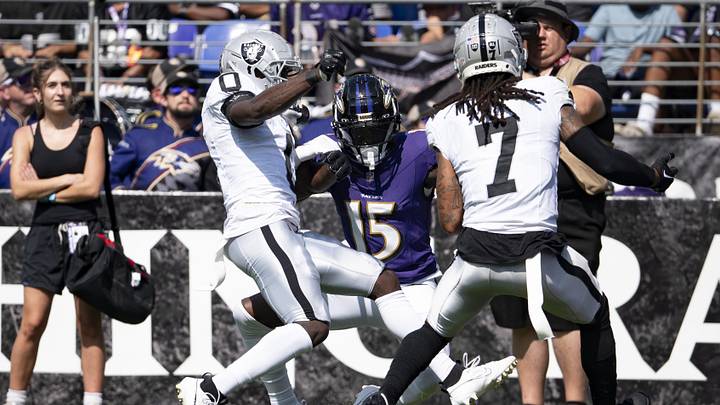 Sep 15, 2024; Baltimore, Maryland, USA;  h15] can’t secure a a pass as Las Vegas Raiders cornerback Jakorian Bennett (0) and  safety Tre'von Moehrig (7) defend during the first half at M&T Bank Stadium. Mandatory Credit: Tommy Gilligan-Imagn Images