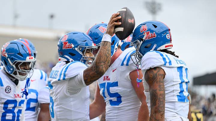 Mississippi Rebels quarterback Trinidad Chambliss celebrates with his teammates after scoring a touchdown. Mandatory Credit: Steve Roberts-Imagn Images Mississippi Rebels quarterback Trinidad Chambliss celebrates with his teammates after scoring a touchdown. Mandatory Credit: Steve Roberts-Imagn Images