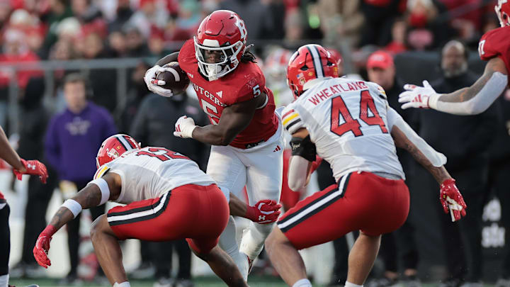 Nov 25, 2023; Piscataway, New Jersey, USA; Rutgers Scarlet Knights running back Kyle Monangai (5) gains yards after catch as Maryland Terrapins defensive back Dante Trader Jr. (12) and linebacker Caleb Wheatland (44) pursue during the first half at SHI Stadium. Mandatory Credit: Vincent Carchietta-Imagn Images