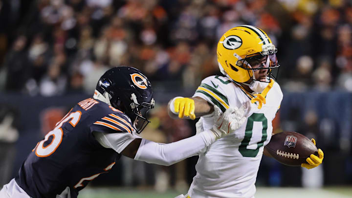 Dec 20, 2025; Chicago, Illinois, USA; Green Bay Packers wide receiver Matthew Golden (0) runs with the ball against Chicago Bears cornerback Nahshon Wright (26) during the first quarter at Soldier Field. Mandatory Credit: Mike Dinovo-Imagn Images