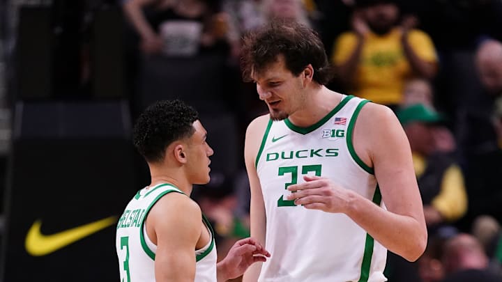 Two Oregon natives, Nate Bittle and Jackson Shelstad confer during Oregon's 72-59 win over Indiana at the Big Ten Tournament.