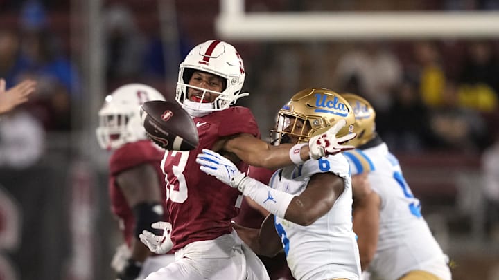 Oct 21, 2023; Stanford, California, USA; UCLA Bruins defensive back John Humphrey (6) breaks up a pass intended for Stanford Cardinal wide receiver Elic Ayomanor (left) during the third quarter at Stanford Stadium. Mandatory Credit: Darren Yamashita-Imagn Images