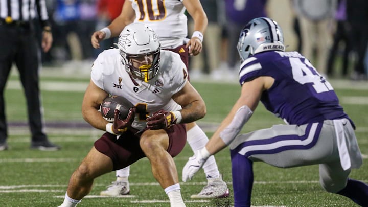 Nov 16, 2024; Manhattan, Kansas, USA; Arizona State Sun Devils running back Cam Skattebo (4) runs the ball against Kansas State Wildcats linebacker Austin Moore (41) during the first quarter at Bill Snyder Family Football Stadium. Mandatory Credit: Scott Sewell-Imagn Images