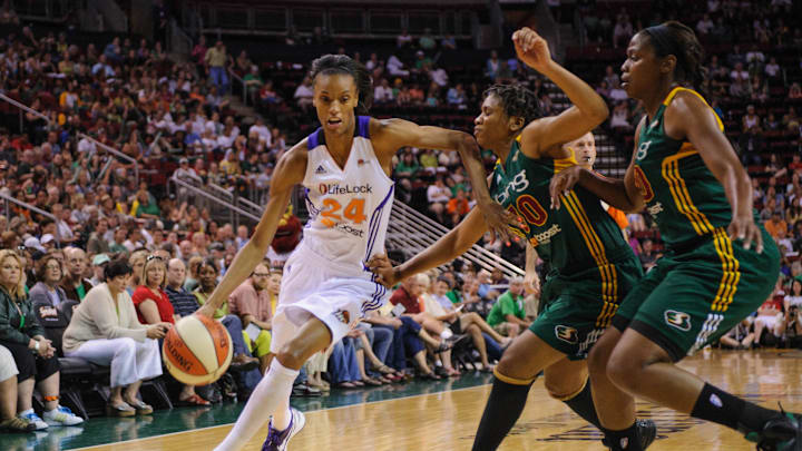 Jul 8, 2012; Seattle, WA, USA; Phoenix Mercury forward DeWanna Bonner (24) moves towards the basket while being guarded by Seattle Storm guard Tanisha Wright (30) during the 1st half at KeyArena. Mandatory Credit: Steven Bisig-Imagn Images