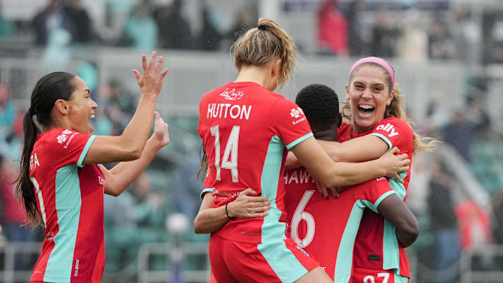Kansas City Current forward Temwa Chawinga (6) celebrates with defender Kayla Sharples (27) after scoring a goal against the North Carolina Courage in a NWSL playoff match at CPKC Stadium.