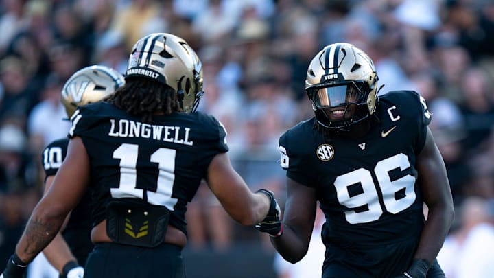Vanderbilt linebacker Bryan Longwell (11) and Vanderbilt defensive lineman Khordae Sydnor (96) celebrate a stop against Charleston Southern during their game at FirstBank Stadium in Nashville, Tenn., Saturday, Aug. 30, 2025.
