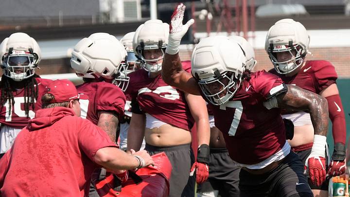 Aug. 7, 2026; Tuscaloosa, AL, USA;  Linebacker Caleb Woodson breaks through a block during practice for the Alabama Crimson Tide.