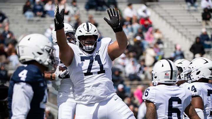 Penn State offensive lineman Vega Ioane (71) celebrates with running back Quinton Martin after the freshman scored a touchdown during the Blue-White game at Beaver Stadium on Saturday, April 13, 2024, in State College. The White team defeated the Blue team, 27-0.