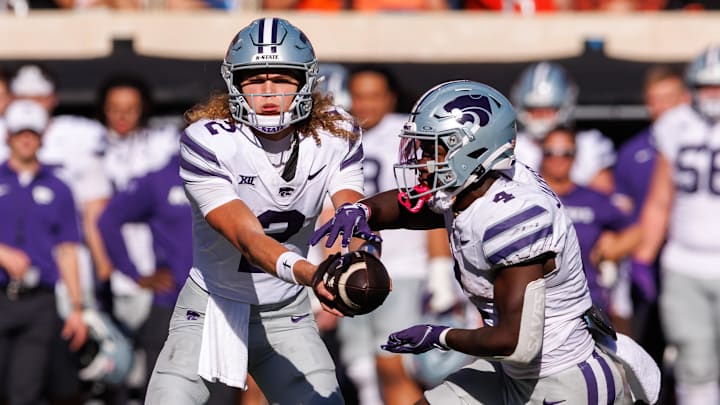 Nov 15, 2025; Stillwater, Oklahoma, USA; Kansas State Wildcats quarterback Avery Johnson (2) hands off to Kansas State Wildcats running back Joe Jackson (4) during the second half against the Oklahoma State Cowboys at Boone Pickens Stadium. Mandatory Credit: William Purnell-Imagn Images