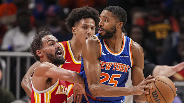 Nov 6, 2024; Atlanta, Georgia, USA; New York Knicks forward Mikal Bridges (25) keeps the ball away from Atlanta Hawks guard Trae Young (11) during the second half at State Farm Arena. Mandatory Credit: Dale Zanine-Imagn Images