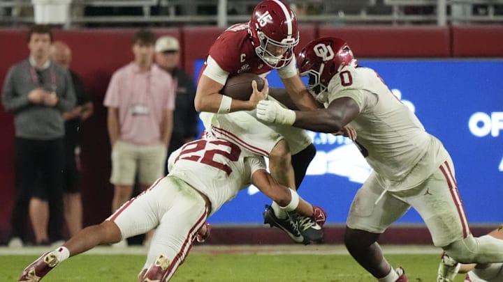Oklahoma defensive tackle David Stone (0) and safety Peyton Bowen (22) hit Alabama quarterback Ty Simpson. Oklahoma defensive tackle David Stone (0) and safety Peyton Bowen (22) hit Alabama quarterback Ty Simpson.