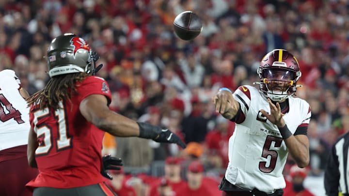 Jan 12, 2025; Tampa, Florida, USA; Washington Commanders quarterback Jayden Daniels (5) throws against Tampa Bay Buccaneers linebacker J.J. Russell (51) during the fourth quarter of a NFC wild card playoff at Raymond James Stadium. Mandatory Credit: Kim Klement Neitzel-Imagn Images Jan 12, 2025; Tampa, Florida, USA; Washington Commanders quarterback Jayden Daniels (5) throws against Tampa Bay Buccaneers linebacker J.J. Russell (51) during the fourth quarter of a NFC wild card playoff at Raymond James Stadium. Mandatory Credit: Kim Klement Neitzel-Imagn Images
