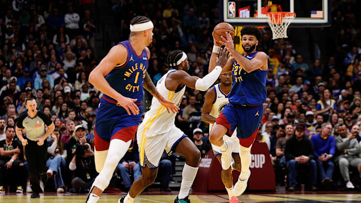 Dec 3, 2024; Denver, Colorado, USA; Denver Nuggets guard Jamal Murray (27) passes the ball to forward Michael Porter Jr. (1) as Golden State Warriors guard Buddy Hield (7) defends in the third quarter at Ball Arena. Mandatory Credit: Isaiah J. Downing-Imagn Images