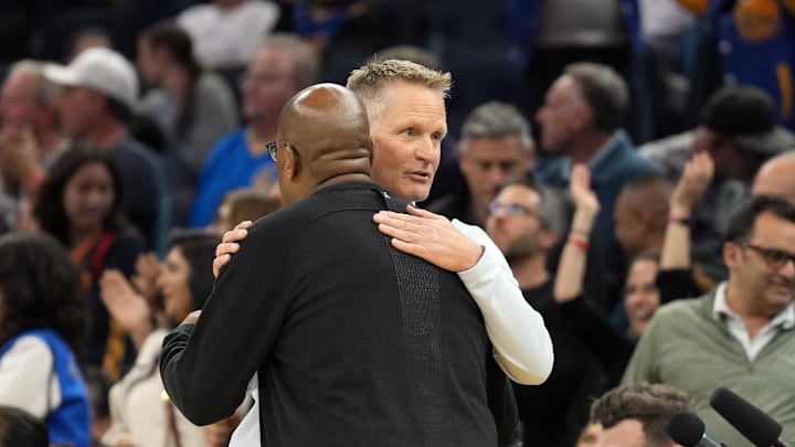 Golden State Warriors head coach Steve Kerr talks to Sacramento Kings head coach Mike Brown.