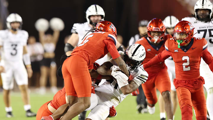 Sep 27, 2025; Ames, Iowa, USA; Iowa State Cyclones wide receiver Chase Sowell (0) is tackled by Arizona Wildcats defensive back Marquis Groves-Killebrew (5) during the second half at Jack Trice Stadium. Mandatory Credit: Reese Strickland-Imagn Images Sep 27, 2025; Ames, Iowa, USA; Iowa State Cyclones wide receiver Chase Sowell (0) is tackled by Arizona Wildcats defensive back Marquis Groves-Killebrew (5) during the second half at Jack Trice Stadium. Mandatory Credit: Reese Strickland-Imagn Images