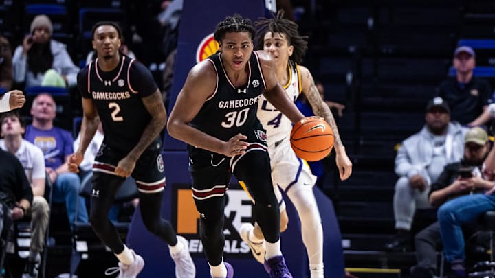 Feb 18, 2025; Baton Rouge, Louisiana, USA;  South Carolina Gamecocks forward Collin Murray-Boyles (30) dribbles against LSU Tigers guard Dji Bailey (4) during the second half at Pete Maravich Assembly Center. Mandatory Credit: Stephen Lew-Imagn Images
