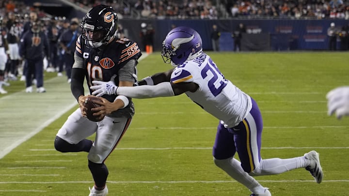 Sep 8, 2025; Chicago, Illinois, USA; Chicago Bears quarterback Caleb Williams (18) rushes the ball past Minnesota Vikings safety Theo Jackson (26) during the second half at Soldier Field. Mandatory Credit: David Banks-Imagn Images