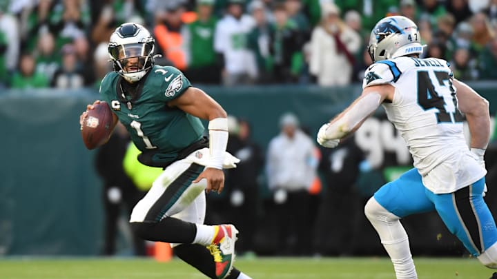 Dec 8, 2024; Philadelphia, Pennsylvania, USA; Philadelphia Eagles quarterback Jalen Hurts (1) is pressured by Carolina Panthers linebacker Josey Jewell (47) at Lincoln Financial Field.