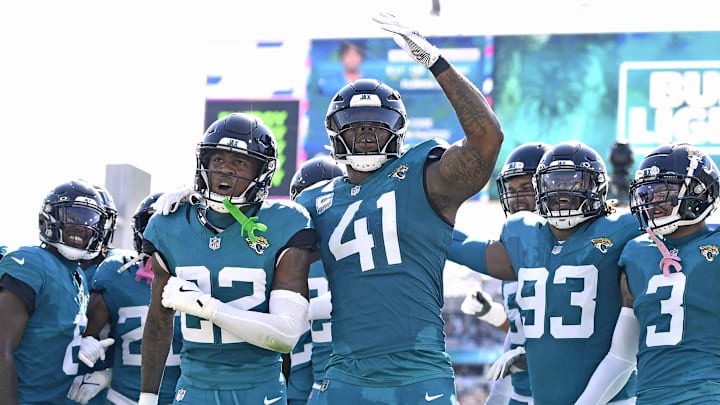 Oct 27, 2024; Jacksonville, Florida, USA; Jacksonville Jaguars defensive back Jarrian Jones (22) celebrates after an interception with defensive end Josh Hines-Allen (41) during the first half against the Green Bay Packers at EverBank Stadium. Mandatory Credit: Melina Myers-Imagn Images