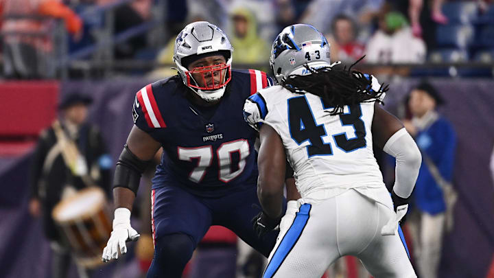 New England Patriots offensive tackle Caedan Wallace (70) lines up with Carolina Panthers linebacker Luiji Vilain.