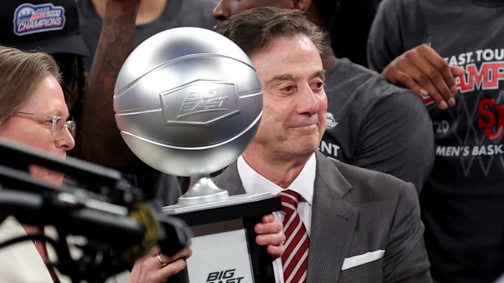 Mar 15, 2025; New York, NY, USA; Big East Conference commissioner Val Ackerman (left) hands the championship trophy to St. John's Red Storm head coach Rick Pitino after St. John's basketball defeated the Creighton Bluejays to win the Big East Tournament at Madison Square Garden.