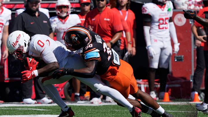 Oklahoma State Cowboys linebacker Trip White (30) brings down Houston Cougars wide receiver Amare Thomas (0) during a college football game between the Oklahoma State Cowboys (OSU) and the Houston Cougars at Boone Pickens Stadium in Stillwater, Okla., Saturday, Oct. 11, 2025. Houston won 39-17. Oklahoma State Cowboys linebacker Trip White (30) brings down Houston Cougars wide receiver Amare Thomas (0) during a college football game between the Oklahoma State Cowboys (OSU) and the Houston Cougars at Boone Pickens Stadium in Stillwater, Okla., Saturday, Oct. 11, 2025. Houston won 39-17.