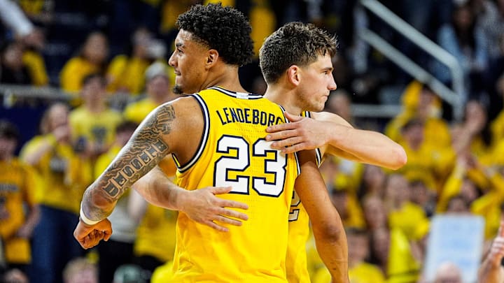 Michigan forward Yaxel Lendeborg (23) hugs forward Will Tschetter (42) after a play against Michigan State during the second half at Crisler Center in Ann Arbor on Sunday, March 8, 2026.