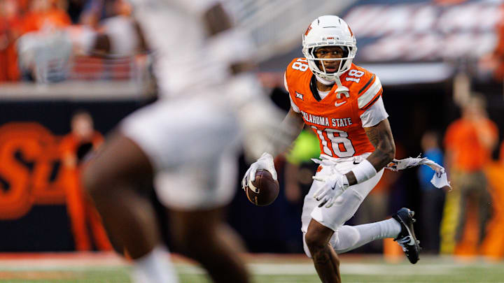 Aug 28, 2025; Stillwater, Oklahoma, USA; Oklahoma State Cowboys wide receiver Sam Jackson V (18) looks to pass during the first half against the Tennessee Martin Skyhawks  at Boone Pickens Stadium. Mandatory Credit: William Purnell-Imagn Images