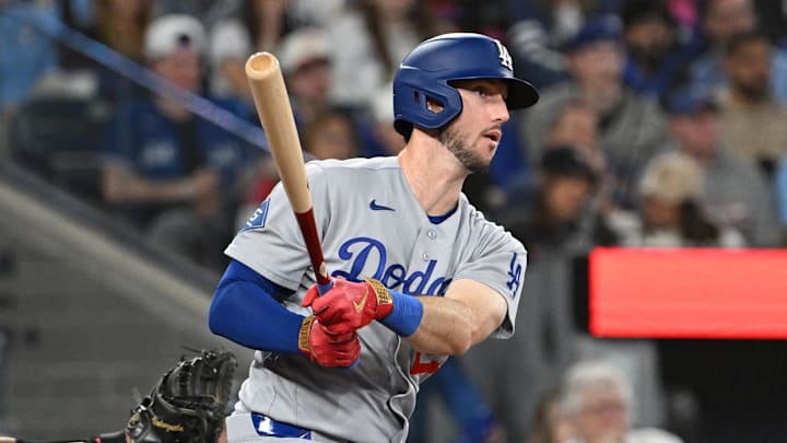 Apr 7, 2026; Toronto, Ontario, CAN; Los Angeles Dodgers right fielder Kyle Tucker (23) hits an RBI double against the Toronto Blue Jays in the ninth inning at Rogers Centre. Mandatory Credit: Dan Hamilton-Imagn Images