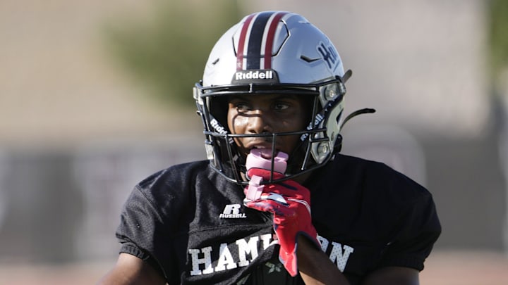 Defensive back/wide receiver Dajon Hinton puts his mouthguard in during practice at Hamilton HS football field on Aug 26, 2024, in Chandler.