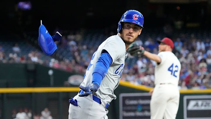 Chicago Cubs center fielder Cody Bellinger (42) tosses an arm protector after drawing a walk against