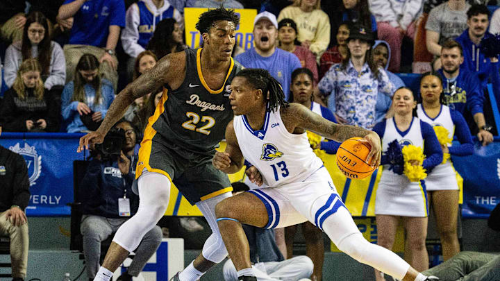 Delaware Fightin' Blue Hens forward Jy'are Davis (13) handles the ball against St. John's basketball transfer portal target Amari Williams