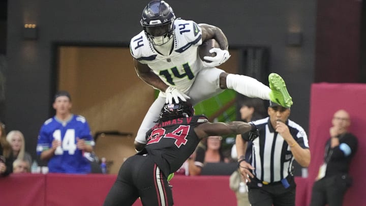 Seattle Seahawks wide receiver DK Metcalf (14) jumps over Arizona Cardinals cornerback Starling Thomas V (24) during the second quarter at State Farm Stadium in Glendale on Dec. 8, 2024. Seattle Seahawks wide receiver DK Metcalf (14) jumps over Arizona Cardinals cornerback Starling Thomas V (24) during the second quarter at State Farm Stadium in Glendale on Dec. 8, 2024.