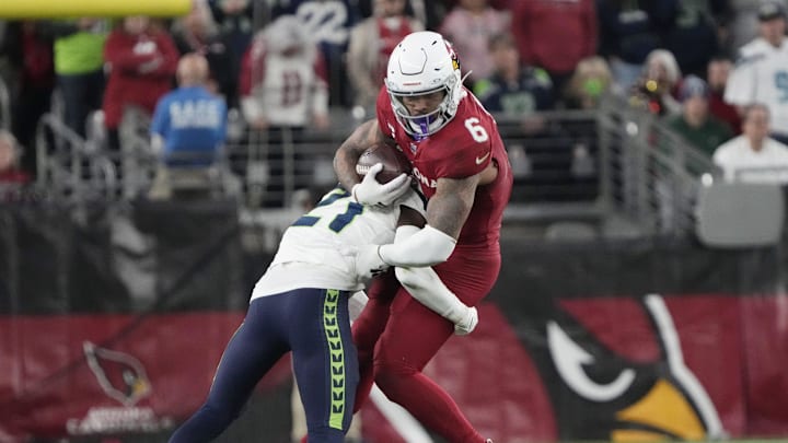 Arizona Cardinals running back James Conner (6) is tackled by Seattle Seahawks cornerback Devon Witherspoon (21) during the fourth quarter at State Farm Stadium in Glendale on Jan. 7, 2024.