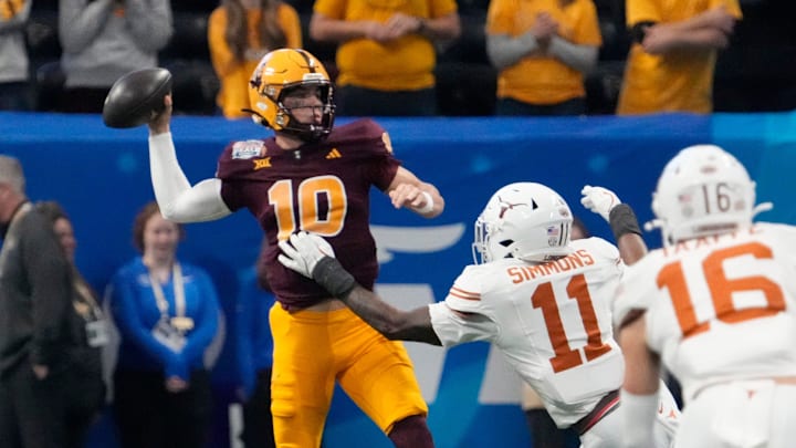 Arizona State quarterback Sam Leavitt (10) throws under pressure by Texas linebacker Colin Simmons (11) during the first quarter of the Chick-fil-A Peach Bowl in Atlanta on Wednesday, Jan. 1, 2025.