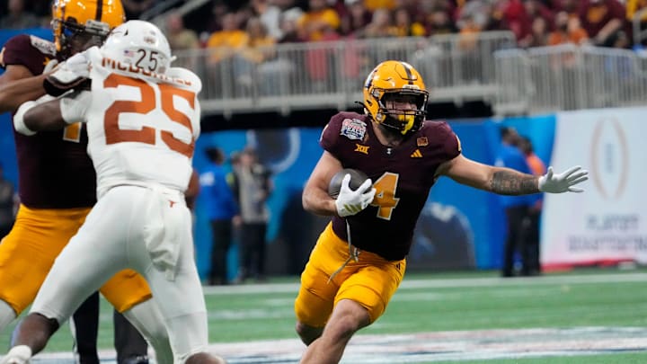 Arizona State running back Cam Skattebo (4) runs against Texas defensive back Jelani McDonald (25) during the third quarter of the Chick-fil-A Peach Bowl in Atlanta on Jan. 1, 2025.