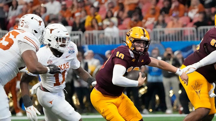 Arizona State quarterback Sam Leavitt (10) scrambles away from Texas linebacker Colin Simmons (11) during the second quarter of the Chick-fil-A Peach Bowl in Atlanta on Wednesday, Jan. 1, 2025. Arizona State quarterback Sam Leavitt (10) scrambles away from Texas linebacker Colin Simmons (11) during the second quarter of the Chick-fil-A Peach Bowl in Atlanta on Wednesday, Jan. 1, 2025.
