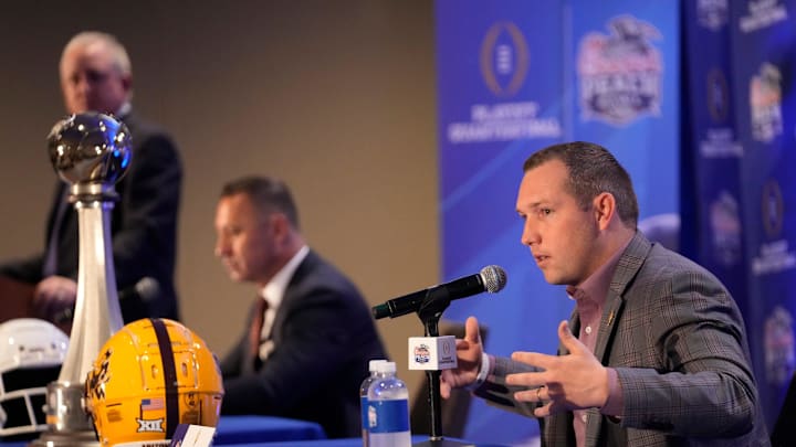 Arizona State head coach Kenny Dillingham responds to a question during a joint news conference with Texas head coach Steve Sarkisian before facing off in the Chick-fil-A Peach Bowl.