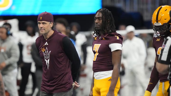 Former Arizona State quarterback Jake Plummer walks out with players for the coin toss against Texas in the Chick-fil-A Peach Bowl in Atlanta on Jan. 1, 2025.