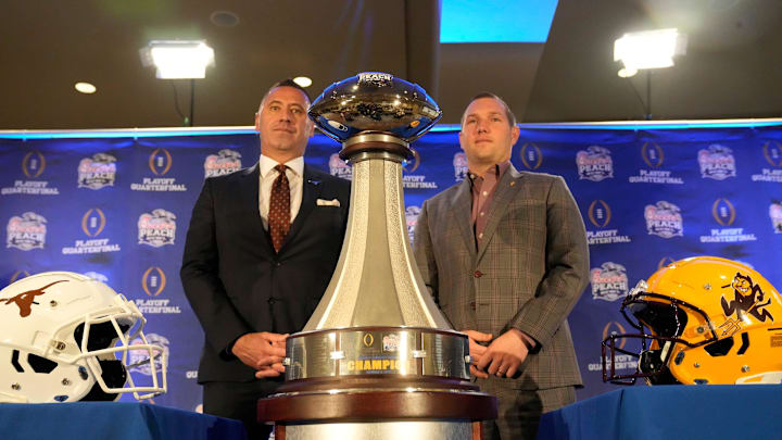 Texas head coach Steve Sarkisian and Arizona State head coach Kenny Dillingham pose for photos before facing off in the Chick-fil-A Peach Bowl.