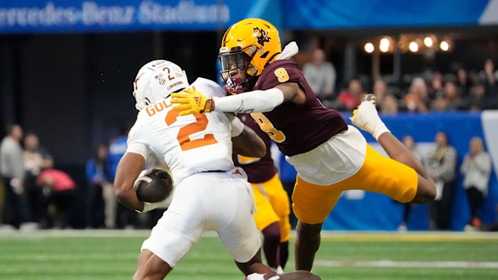 Texas wide receiver Matthew Golden (2) is tackled by Arizona State defensive back Montana Warren (9) during the second quarter of the Chick-fil-A Peach Bowl in Atlanta on Wednesday, Jan. 1, 2025.