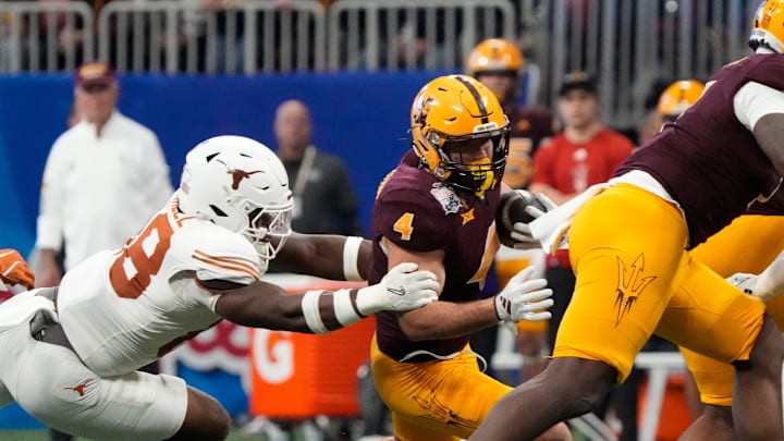 Arizona State running back Cam Skattebo (4) is tackled by Texas linebacker Barryn Sorrell (88) during the first quarter of the Chick-fil-A Peach Bowl in Atlanta on Wednesday, Jan. 1, 2025.