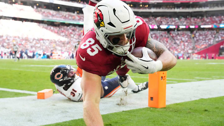 Arizona Cardinals tight end Trey McBride (85) hits the turf after scoring against Chicago Bears safety Kevin Byard III (31) during the first quarter at State Farm Stadium in Glendale on Nov. 3, 2024.