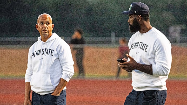 From left, Penn State football head coach James Franklin and Nittany Lions defensive line coach Deion Barnes watch the Appoquinimink vs. Howard football game at Appoquinimink in Middletown on Sept. 19, 2025. Howard won 46-39.