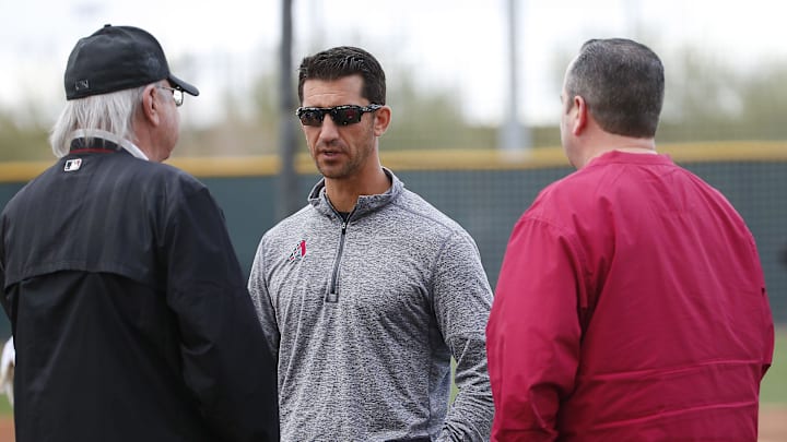 Diamondbacks General Manager Mike Hazen (center) talks with Managing General Partner Ken Kendrick (left) and President and CEO Derrick Hall at spring training in 2018.

Diamondbacks Spring Training