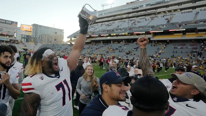 Nov 25, 2023; Tempe, Arizona, USA; Arizona offensive lineman Jonah Savaiinaea (71) celebrates after winning the Territorial Cup against Arizona State 59-23 at Mountain America Stadium. Mandatory Credit: Michael Chow-Arizona Republic