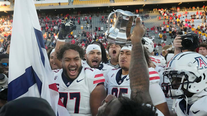 Nov 25, 2023; Tempe, Arizona, USA; Arizona players celebrate after winning the Territorial Cup against Arizona State 59-23 at Mountain America Stadium. Mandatory Credit: Michael Chow-Arizona Republic
