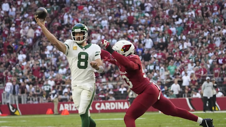 New York Jets quarterback Aaron Rodgers (8) throws while pressured by Arizona Cardinals linebacker Baron Browning (53) during the first quarter at State Farm Stadium in Glendale on Nov. 10, 2024. New York Jets quarterback Aaron Rodgers (8) throws while pressured by Arizona Cardinals linebacker Baron Browning (53) during the first quarter at State Farm Stadium in Glendale on Nov. 10, 2024.