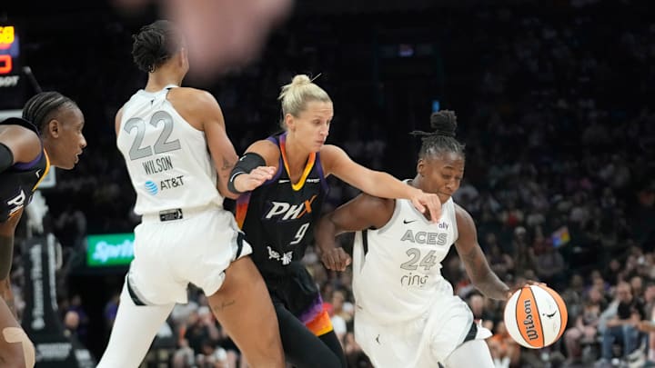 Phoenix Mercury guard Kitija Laksa (9) fights over a screen by Las Vegas Aces center A'ja Wilson (22) while defending guard Jewell Loyd (24) during the first quarter at PHX Arena Jun 29, 2025.